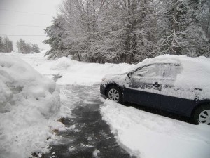 Snow on car and driveway