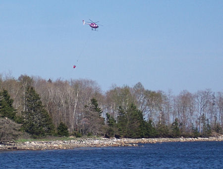 Water-bombing helicopter over Oak Island.